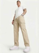 Redefine your everyday carry and comfort with the BREXX Urban Utility Beige Cargo Pants. Designed for the man who values both function and fashion, these trousers are the ultimate addition to a versatile wardrobe. Whether you are navigating the urban jungle or heading out for a casual weekend, the structured design ensures you look sharp without compromising on comfort. Key Features & Benefits: Premium Cotton Twill: Crafted from high-grade, breathable cotton fabric that offers superior durability and a soft hand-feel. Multi-Functional Storage: Equipped with deep side cargo pockets with secure flap closures, perfect for phones, wallets, and keys, plus standard front and back pockets. Modern Tapered Fit: expertly tailored to provide a relaxed feel at the thighs while tapering neatly at the ankles for a clean, contemporary silhouette. Reinforced Construction: Features heavy-duty stitching on belt loops and stress points to ensure longevity. Versatile Styling: The neutral beige tone pairs effortlessly with t-shirts, hoodies, or button-downs for year-round wear. Upgrade your rotation with the pants that work as hard as you do. Experience the perfect blend of tactical utility and street-ready style with BREXX