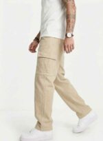 Redefine your everyday carry and comfort with the BREXX Urban Utility Beige Cargo Pants. Designed for the man who values both function and fashion, these trousers are the ultimate addition to a versatile wardrobe. Whether you are navigating the urban jungle or heading out for a casual weekend, the structured design ensures you look sharp without compromising on comfort. Key Features & Benefits: Premium Cotton Twill: Crafted from high-grade, breathable cotton fabric that offers superior durability and a soft hand-feel. Multi-Functional Storage: Equipped with deep side cargo pockets with secure flap closures, perfect for phones, wallets, and keys, plus standard front and back pockets. Modern Tapered Fit: expertly tailored to provide a relaxed feel at the thighs while tapering neatly at the ankles for a clean, contemporary silhouette. Reinforced Construction: Features heavy-duty stitching on belt loops and stress points to ensure longevity. Versatile Styling: The neutral beige tone pairs effortlessly with t-shirts, hoodies, or button-downs for year-round wear. Upgrade your rotation with the pants that work as hard as you do. Experience the perfect blend of tactical utility and street-ready style with BREXX